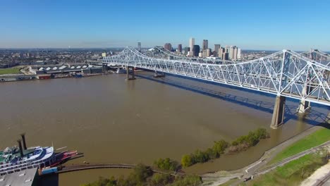 aerial shot of the crescent city bridge over the mississippi river revealing the new orleans louisiana skyline