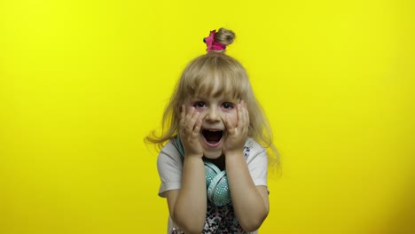 Child-show-amazement,-fooling-around,-smiling,-looking-surprised-shocked-on-yellow-background