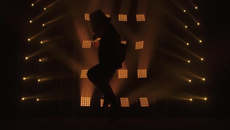 dancer on stage under spotlight