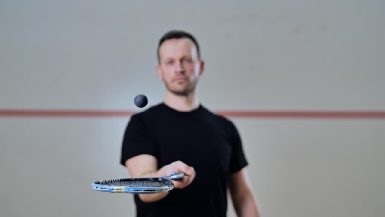 Squash player balances ball above racket in dynamic sports advertisement shot