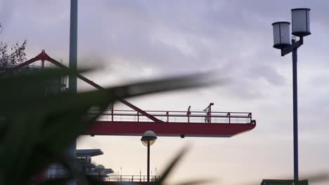 Wind-blowing-through-leafs-and-plants-at-Sunset-with-focus-on-a-city-trampoline,-a-storm-is-set-to-strike-soon-with-terrible-wind-coming-through