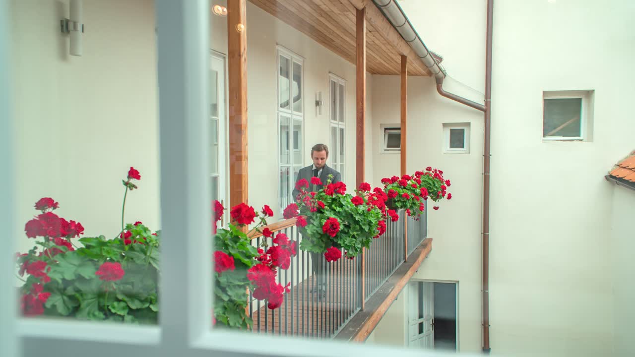 Handsome young man in suit walk house corridor. Tracking shot