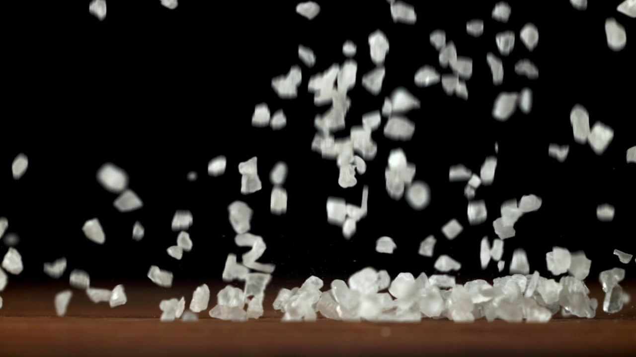 Slow Motion of Coarse Sea Salt Crystals Falling onto a Wooden Surface