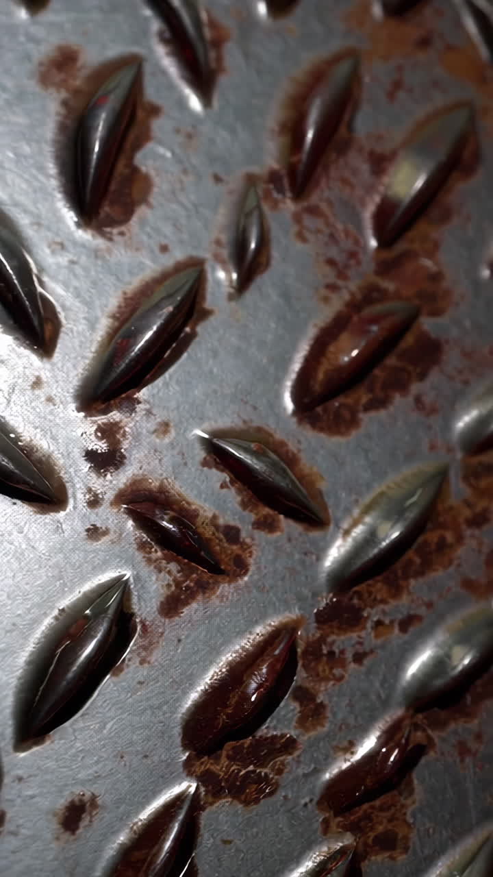 Close-up view of a rusty metal diamond plate