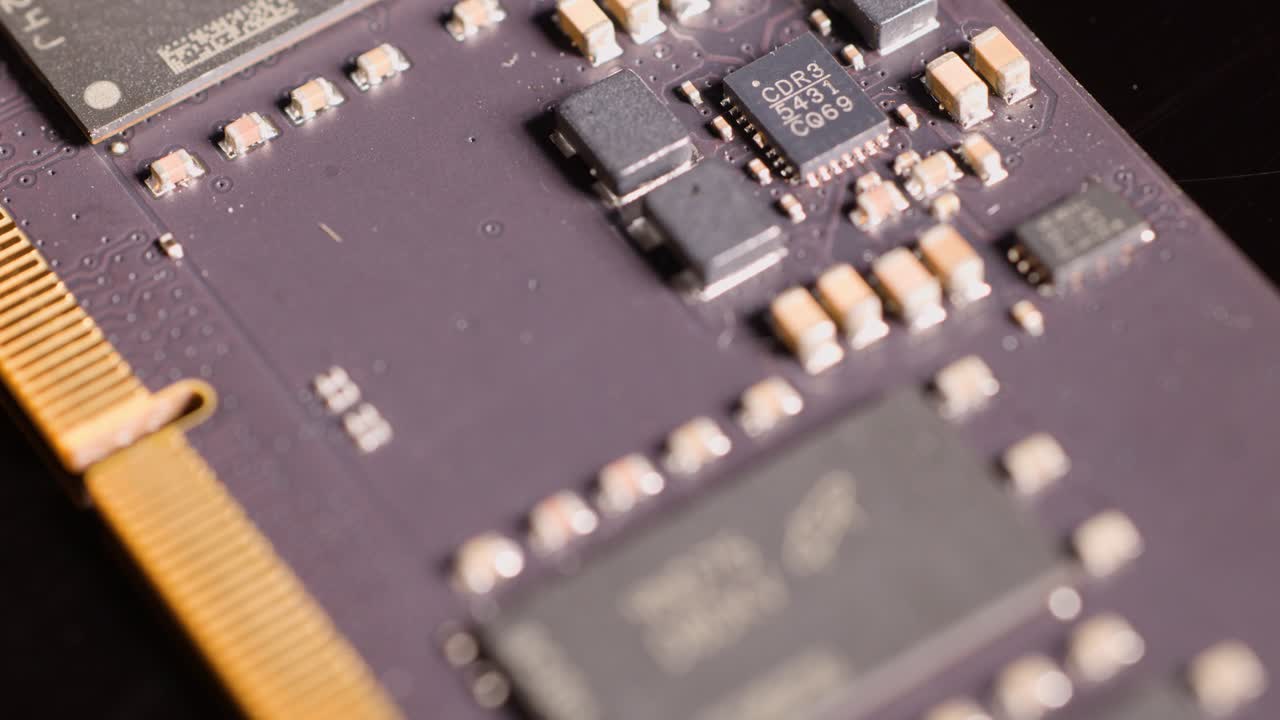 A slow macro camera pan moves across the electronic components of a computer memory module