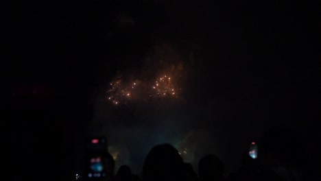 Cinematic-fireworks-scenery-with-people-silhouettes-watching