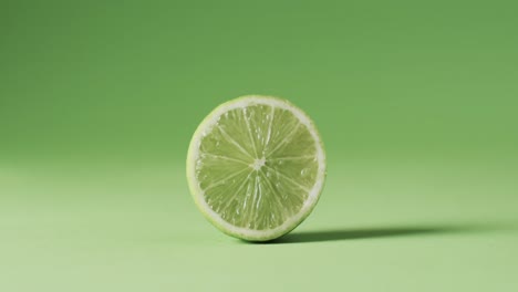 video of sliced lime with copy space over green background