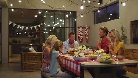 happy family praying before dinner