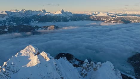 Aerial-reveal-of-the-snow-covered-Peitlerkofel-and-Gardertal-in-South-Tyrol,-Italy,-showcasing-a-stunning-winter-landscape