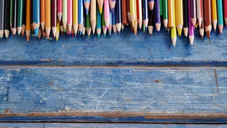 Color-pencils-arranged-on-wooden-table