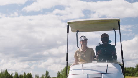 caucasian woman and african american man on the golf course.