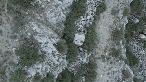 Topdown view of a quarry detail showing rocks, gravel, and sparse vegetation, offering a unique perspective on industrial resource extraction