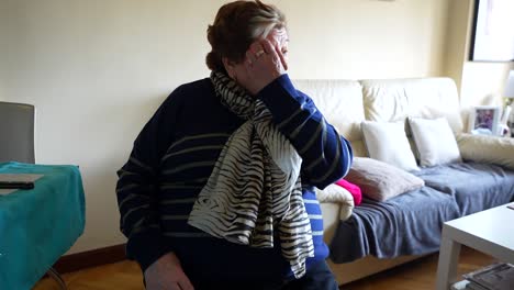 Elderly-woman-sitting-on-a-chair-with-a-weary-expression