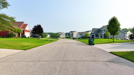 slow pull back along the suburban street in summer