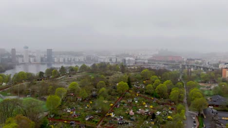 drone shot approaching urban greenery and plantations in stockholm, shrouded in thick morning mist