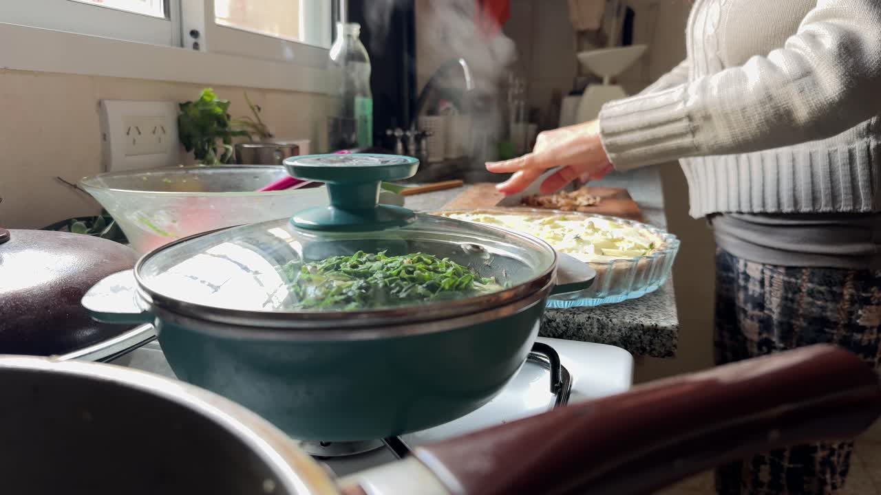 Woman Cooking Spinach and Tart in Home Kitchen