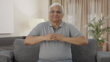 Happy-Indian-old-man-doing-breathe-in-breathe-out-exercise