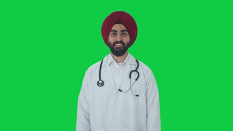 happy sikh indian doctor smiling green screen