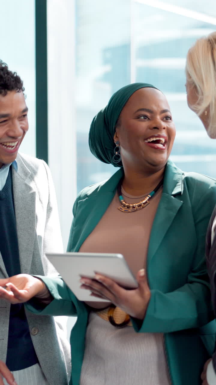 Diverse Business Team Collaborating and Laughing with a Digital Tablet in a Modern Office