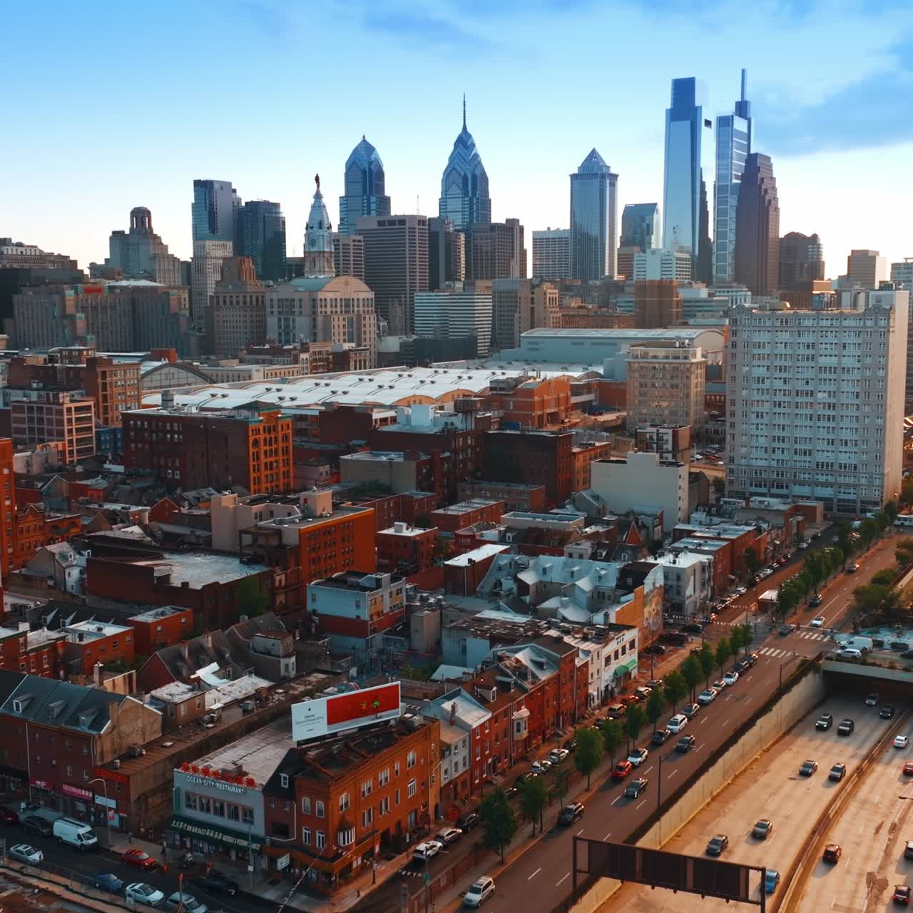 Sight of the Vine Street Expressway in Philadelphia with large amount of cars riding on. Skyscrapers skyline at backdrop