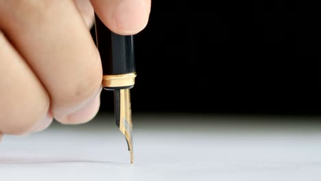 close-up shot hand of woman using the pen to write on the paper