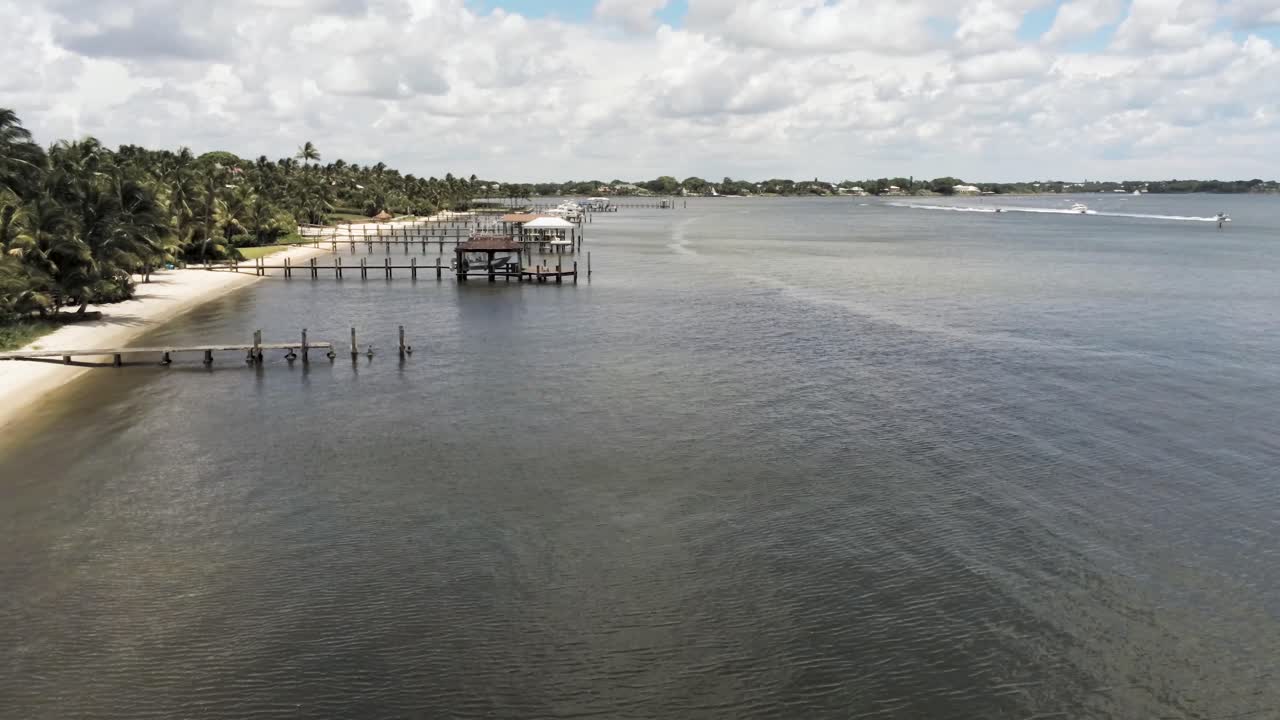 vista aérea de los muelles a lo largo de la costa en el sur de florida, palmeras que soplan en la brisa