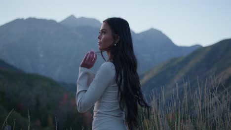 young beautiful woman looks at nature and mountain views