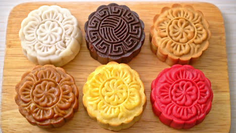 colourful chinese moon cake with mixed flavour on wood plate