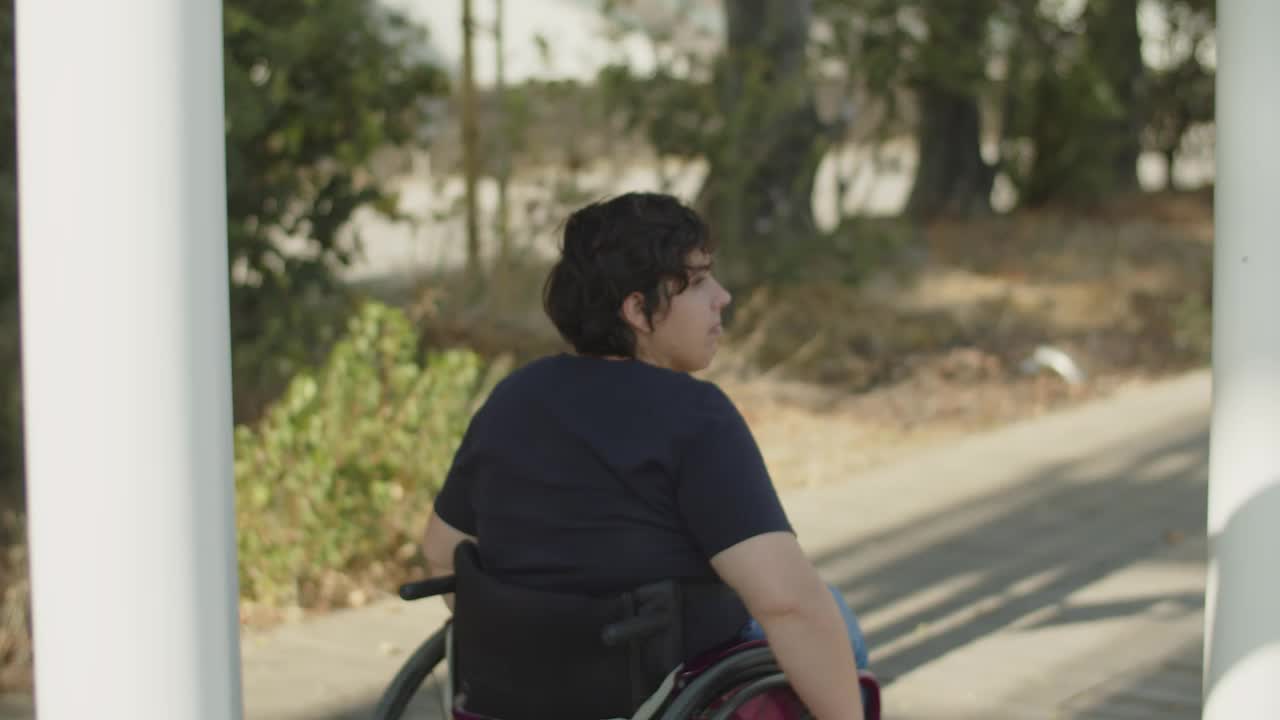 Young woman with disability wheeling in park