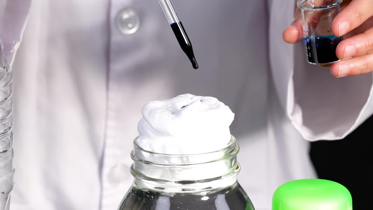Observe blue dye dripping onto foam in a bottle during a hands-on experiment.
