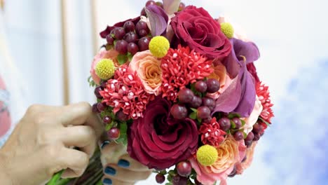 woman preparing a bouquet of flowers for event