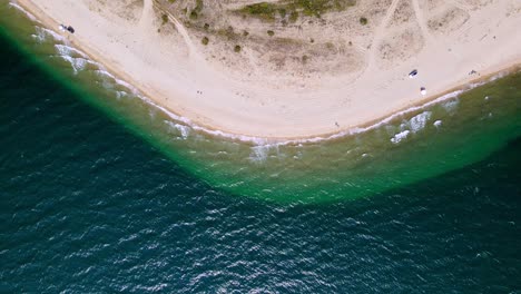 Top-down-drone-clip-over-a-tropical-beach-with-golden-sand-in-the-area-of-Keramoti,-Kavala,-in-Northern-Greece-in-4k