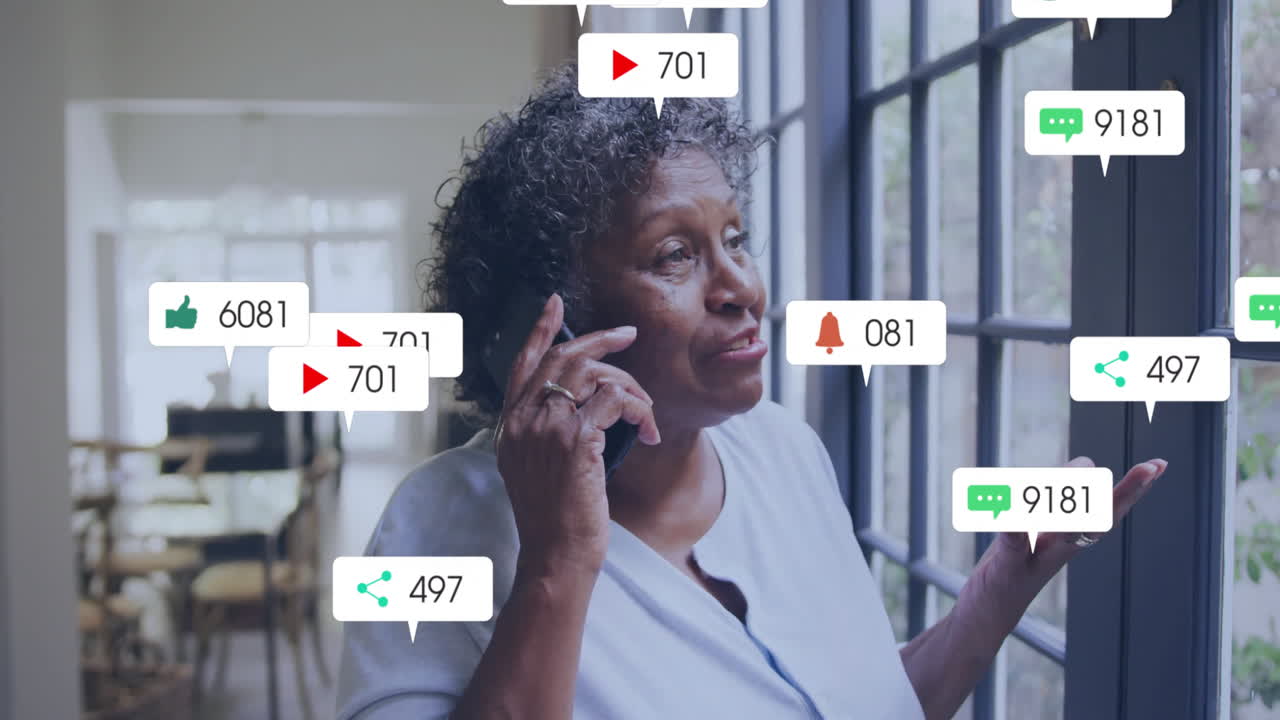 Social media notifications animation over woman talking on phone by window