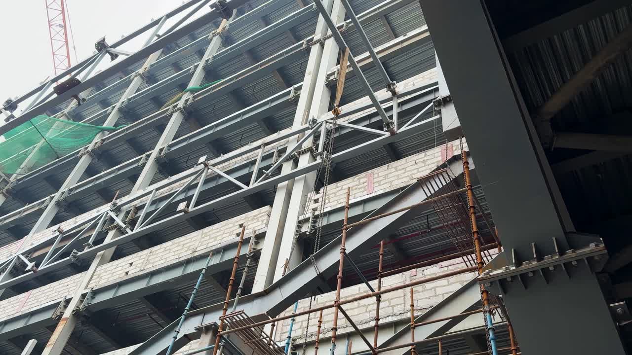 large scale building construction progress with steel trusses and work platforms