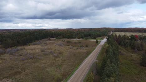 car drives along a side road in rural caledon, aerial shot