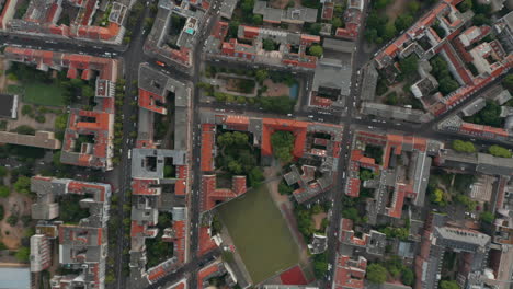 Aerial-birds-eye-overhead-top-down-vertically-panning-view-of-urban-neighbourhood.-Cars-driving-on-streets.-Berlin,-Germany.