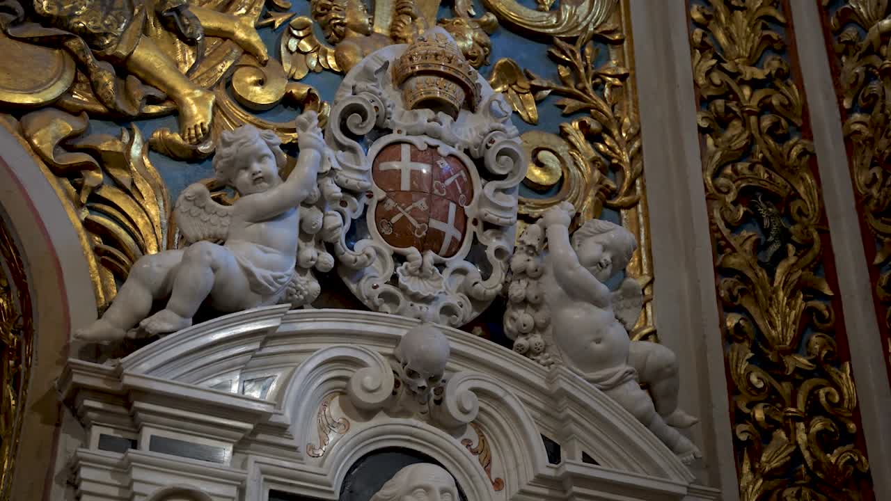 Cherubic baby figures within St John’s Co-Cathedral reflect innocence and divine artistry, symbolising purity and the beauty of baroque religious craftsmanship