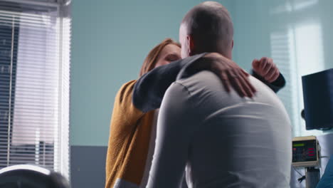 couple hugging in hospital room
