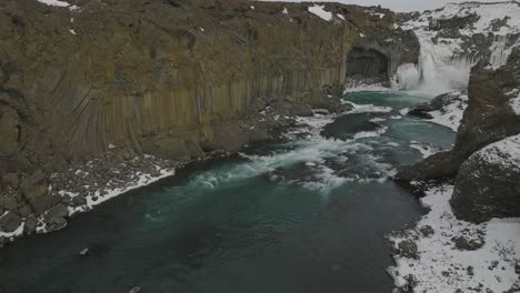 basalt column river cliffs by aldeyjarfoss waterfall in iceland - aerial