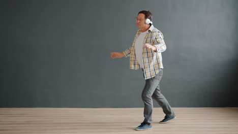 man dancing to music with headphones
