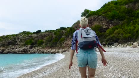 woman running on a beach near mountains