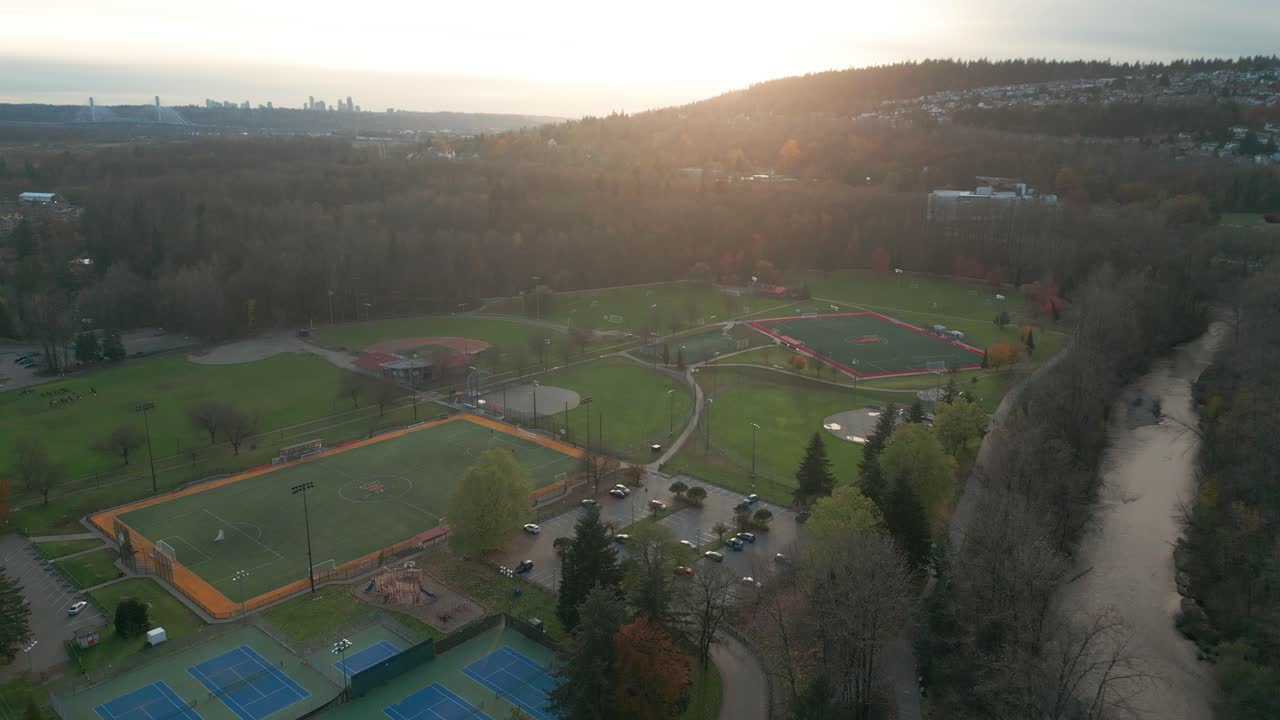 a beautiful golden hour shot of gate's park featuring various sports fields.