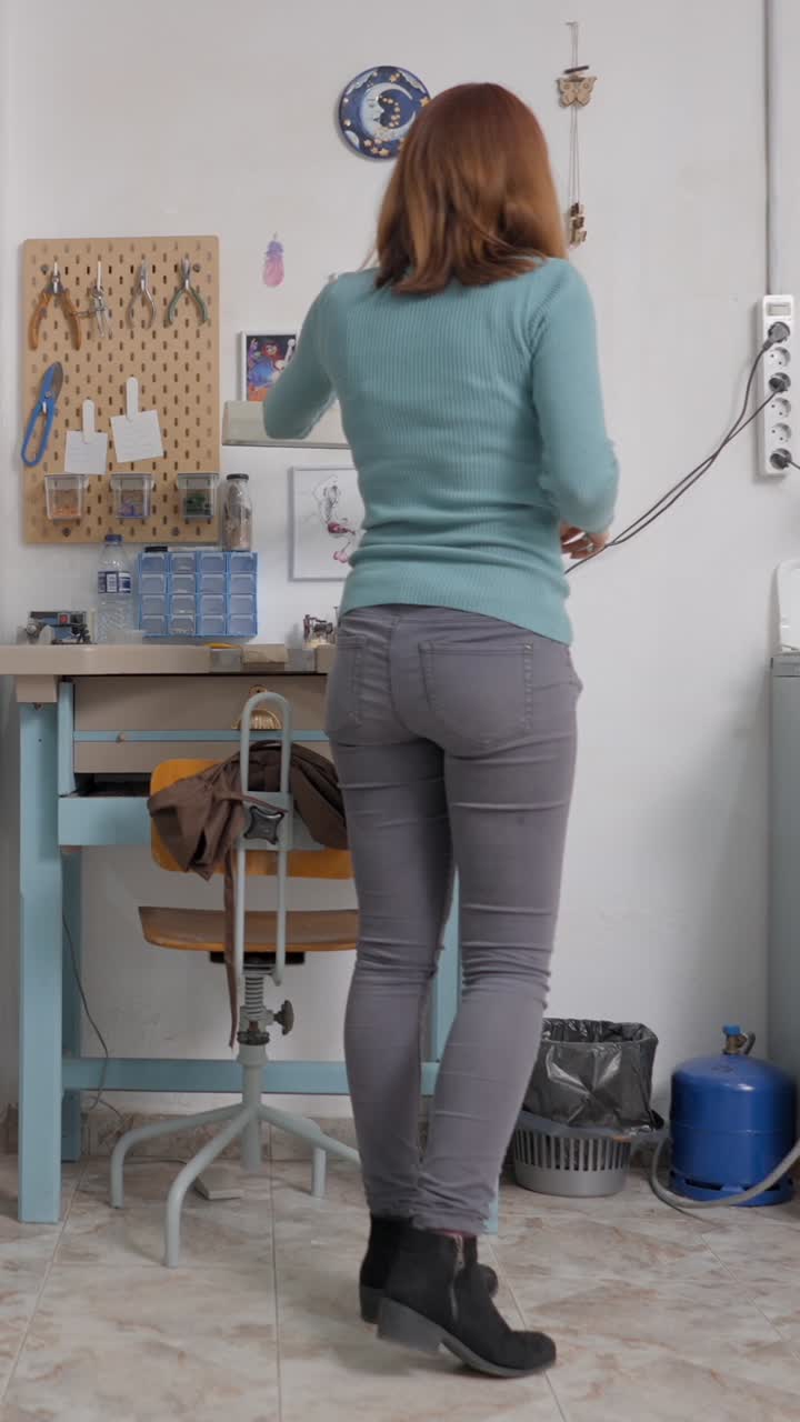 A woman and her dog in an indoor setting, including a workspace