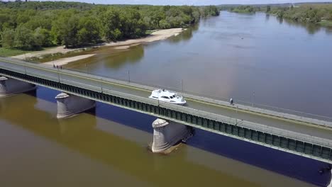 Aerial-view-of-a-boat-crossing-the-aqueduct-at-Briare,-France,-Europe