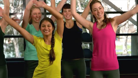 Fit-woman-group-doing-aerobic-exercises-at-the-gym