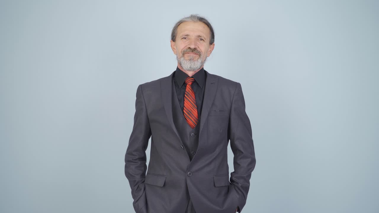 Businessman laughing at camera.