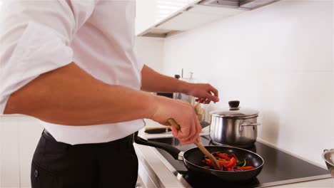 Man-preparing-a-food-in-kitchen