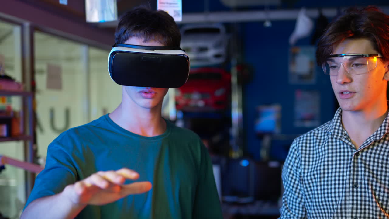 Young engineers with VR virtual reality headset controlling virtual worlds in research laboratory