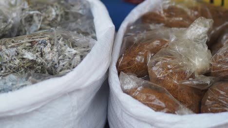 dried herbs and spices in plastic bags at a market
