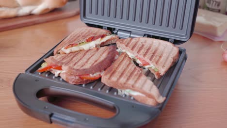 panning view, healthy vegetarian panini sandwich cooking on electric grill